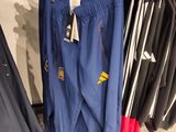 a lot of pants hanging on a rack in a store