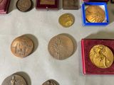 many different types of medals on the table