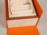 an orange box with a silver ring inside of it