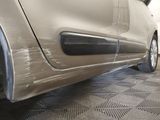 a close up of a car ' s bumper and tire on a checkered floor
