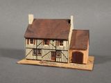 an image of a model of a house with a brown roof
