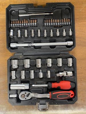 une mallette noire contenant des outils, posée sur une table