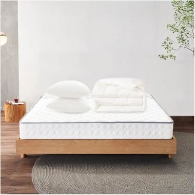 a close up of a mattress on a wooden platform with pillows