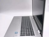 a laptop computer sitting on a white surface