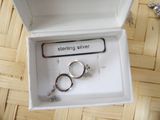 a box with two rings inside of it on the floor