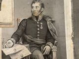 an old picture of a man sitting in a chair