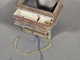 a small box with wires attached to it on the floor