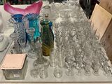 many glasses and vases on a table in a store