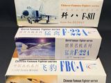 three boxed boxes of chinese planes on a black surface