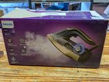 an open box of a steam iron sitting on top of a wooden table