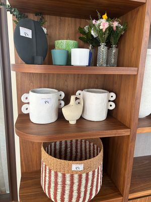 a wooden shelf with a basket on top of it