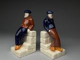 pair of ceramic figurines of two men sitting on blocks