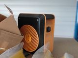 a small radio sitting on top of a table next to some bananas