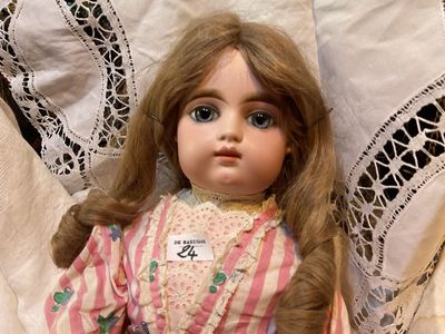 a doll that is laying down on a bed