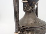 a silver vase with a handle on a white background