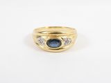 a yellow gold ring with a sapphire and diamonds