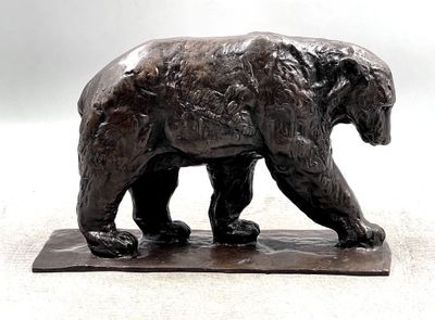 a statue of a bear that is standing on a base