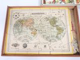 map of the world in a puzzle box with a wooden handle