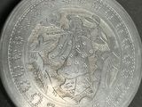 a silver coin with a picture of a man and a woman on it