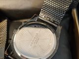 watch in a box with a tie and a watch on it