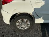 a white car that has been damaged and is parked in the parking lot