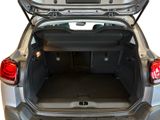 the back of a silver car with its trunk open on a white background