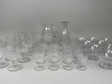 a lot of glasses and a pitcher on the table