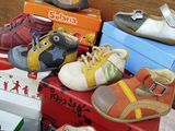 a pile of children ' s shoes sitting on top of a table