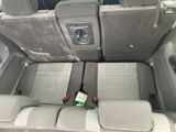 two seats in the back of a car with a bottle of beer in it