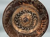 a close up of a plate on a stand on a table