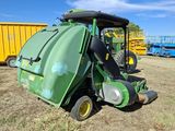 a green tractor that is parked in the grass