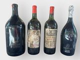 four bottles of wine are lined up in a row on a table