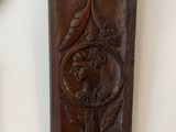 a wooden plaque with a bird on it next to a picture frame