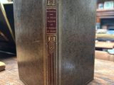 an old book sitting on top of a wooden table