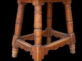 an old wooden stool with a wooden seat on a black background