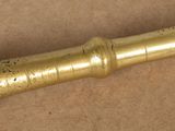 a close up of a brass object on a brown surface