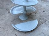 a three tiered cake stand with plates on it