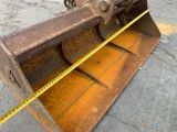 a yellow tape on the ground next to a bulldozer