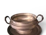 a silver bowl and saucer on a saucer on a saucer