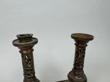 two candles that are sitting on top of a table
