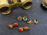 two pairs of binoculars are sitting on a blue surface