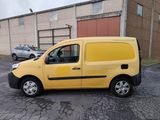 the yellow van is parked in the parking lot near the building