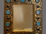 an image of a gold frame with blue stones in it