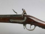a close up of a rifle with a wooden handle on a white background