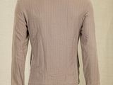 the back of a mannequin mannequin wearing a brown jacket and white pants