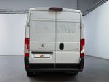 a white van parked in a room with a black floor
