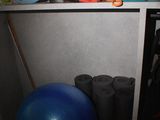 a blue ball sitting on top of a shelf in a room