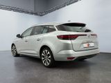 the rear end of a white car parked in a garage