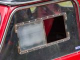 a close up of a red car with a window