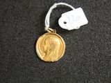 a gold medal with a picture of a woman on it